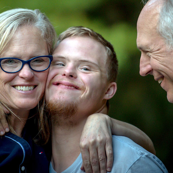 A family hug, sharing a moment of friendship and connection.