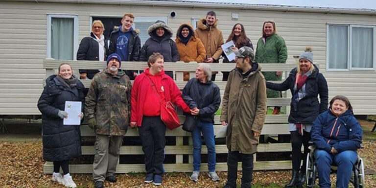 Circles staff in front of the caravan at Overstone Lakes.